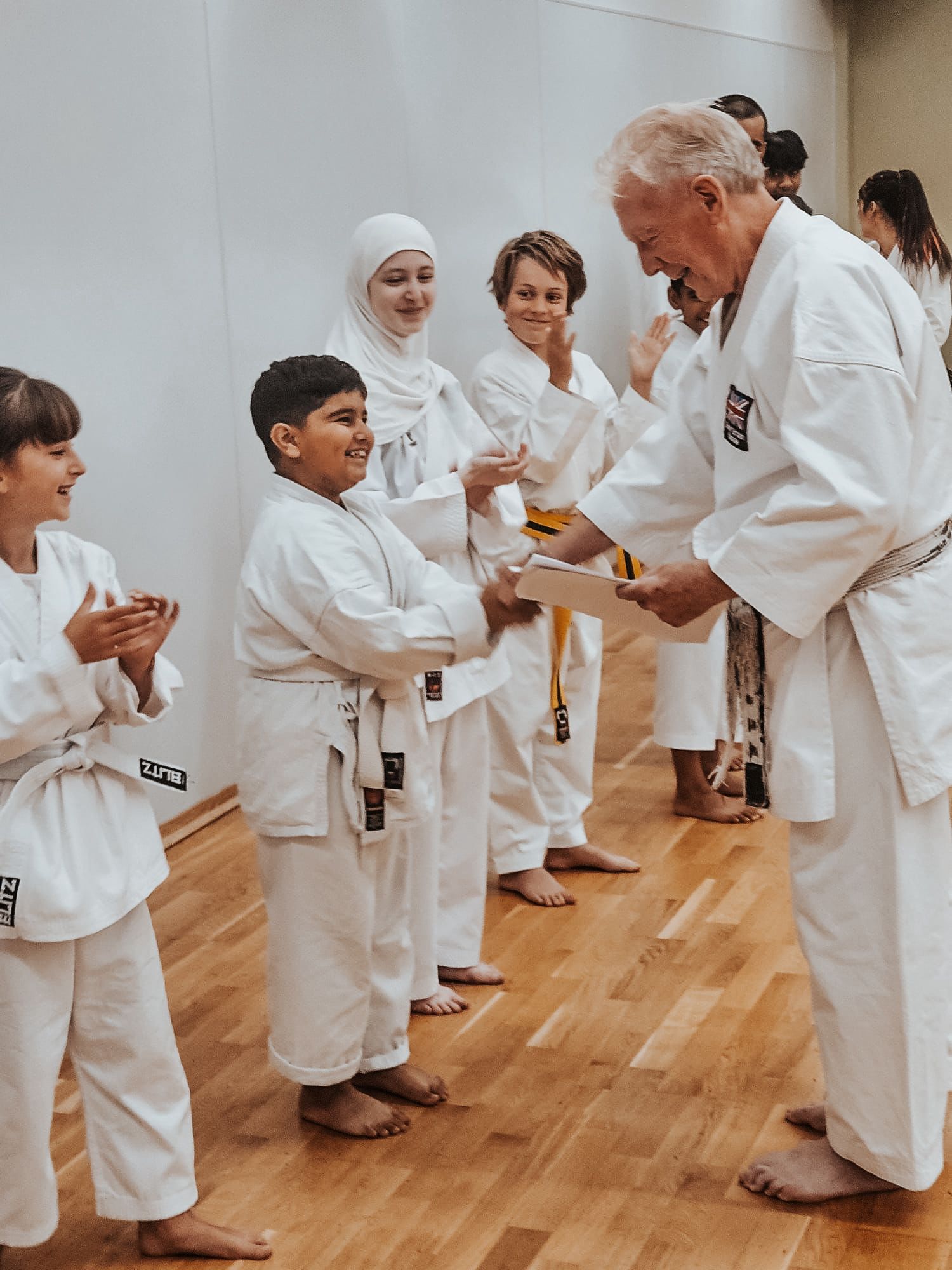 The whole karate club lines up with all members in a karate stance
